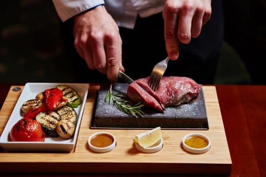 meat grilled on a stone with vegetables on the plate