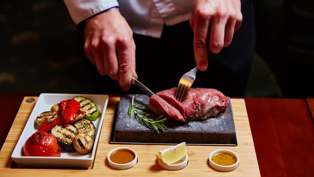 meat grilled on a stone with vegetables on the plate