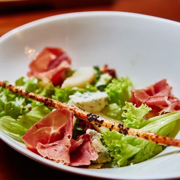 Fresh spring mix salad italian style with prosciutto and Roquefort cheese