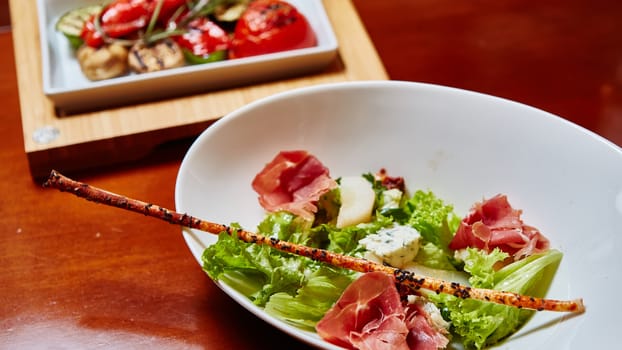 Fresh spring mix salad italian style with prosciutto and Roquefort cheese