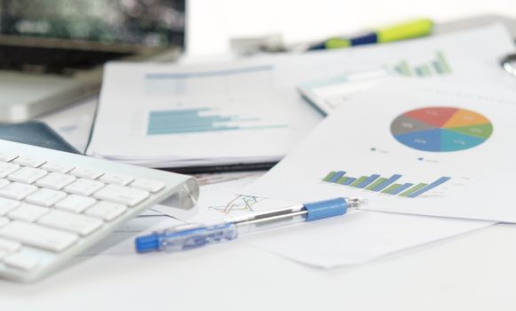 Documents, graphs on a desk.