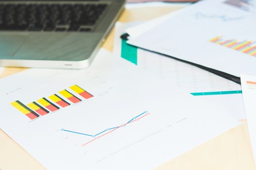 Documents, graphs on a desk.