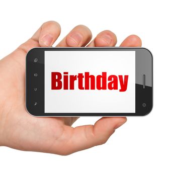 Holiday concept: Hand Holding Smartphone with  red text Birthday on display
