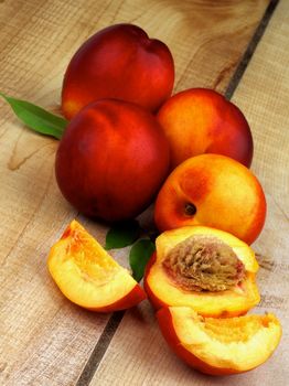 Arrangement of Ripe Peaches Full Body and Slices with Leaf closeup on Wooden background