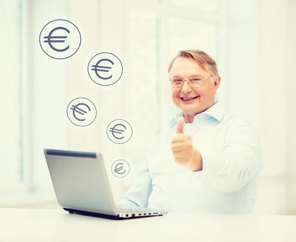 technology, oldness and lifestyle concept - old man in eyeglasses with laptop computer at home showing thumbs up