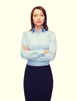 business and education concept - friendly young businesswoman with crossed arms