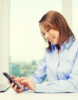 education, business and technology concept - smiling businesswoman or student with laptop computer and smartphone