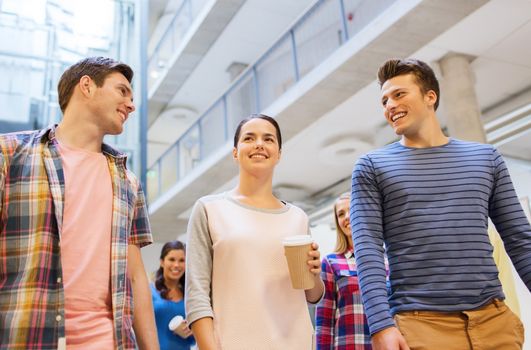 education, high school, friendship, drinks and people concept - group of smiling students with paper coffee cups