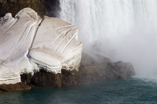 Interesting pattern on the gray snow near the waterfall