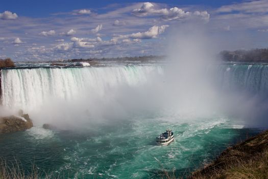 The powerful beautiful Niagara falls and a ship