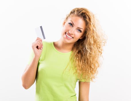 Portrait of beautiful young woman with credit card. White background.