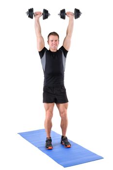 young man fitness instructor shows finishing position of standing dumbbell shoulder press, isolated on white