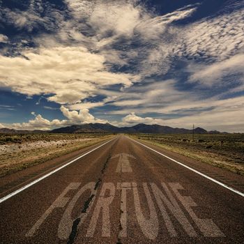 Conceptual image of desert road with the word fortune and arrow