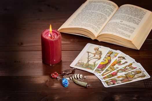 Composition of esoteric objects,candle,Tarots and book used for healing and fortune-telling.