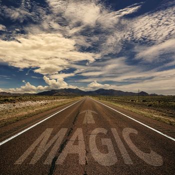 Conceptual image of desert road with the word magic and arrow