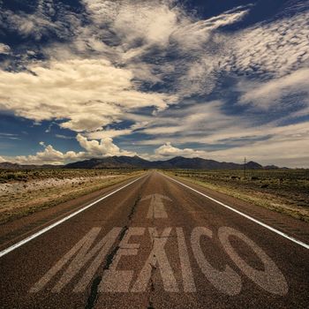 Conceptual image of desert road with the word Mexico and arrow