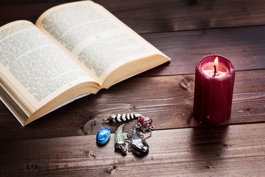 Composition of esoteric objects,candle and book used for healing and fortune-telling.