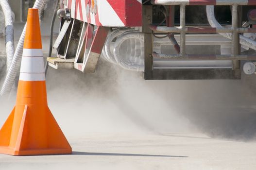 Cold metal pipe and smoke from transferring liquid oxygen at rear of truck.