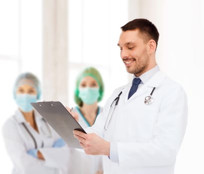 medicine, profession, and healthcare concept - smiling male doctor with clipboard and stethoscope writing prescription over white background