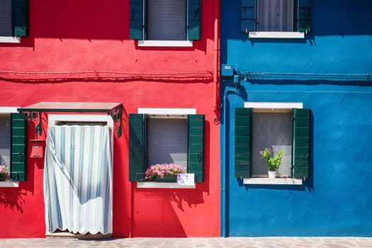 Colourfully painted house facade with windows on Burano island, province of Venice, Italy