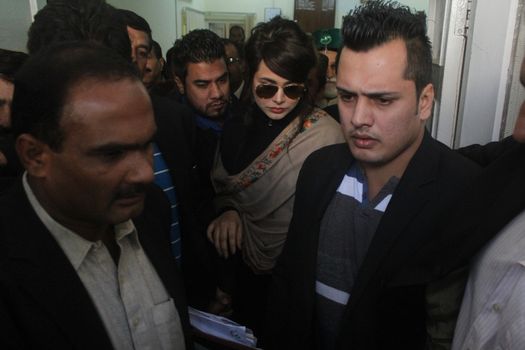 PAKISTAN, Rawalpindi: Pakistani singer and model Ayyan Ali (c) arrives at the court in Rawalpindi, Pakistan, on November 6, 2015. Ali was charged with money laundering after security forces found over $500,000 in her luggage on a flight destined for Dubai, on March 2015.