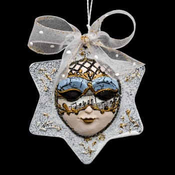 Beautiful mask of hand-worked for festive decoration, isolated on black background