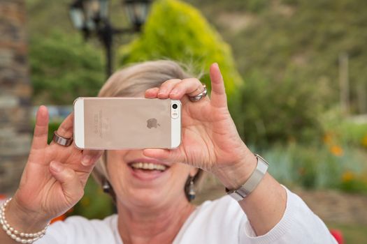 senior woman taking picture with her smartphone