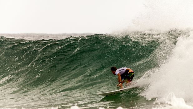 SNAPPER ROCKS, GOLD COAST, AUSTRALIA - 25 FEB: Unidentified Surfer races the Quiksilver & Roxy Pro World Title Event. 25 February 2011, Snapper Rocks, Gold Coast, Australia