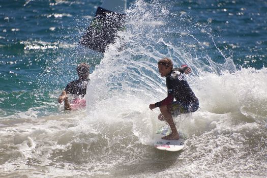 SNAPPER ROCKS, GOLD COAST, AUSTRALIA - 25 FEB: Unidentified Surfer races the Quiksilver & Roxy Pro World Title Event. 25 February 2011, Snapper Rocks, Gold Coast, Australia