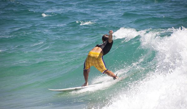 SNAPPER ROCKS, GOLD COAST, AUSTRALIA - 25 FEB: Unidentified Surfer races the Quiksilver & Roxy Pro World Title Event. 25 February 2011, Snapper Rocks, Gold Coast, Australia