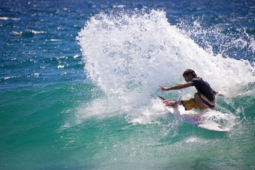 SNAPPER ROCKS, GOLD COAST, AUSTRALIA - 25 FEB: Unidentified Surfer races the Quiksilver & Roxy Pro World Title Event. 25 February 2011, Snapper Rocks, Gold Coast, Australia