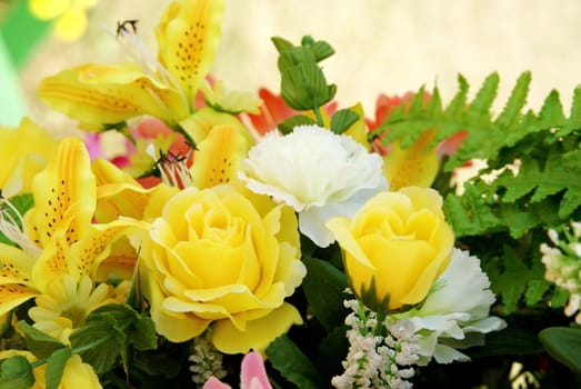 Yellow and white artificia flower with green leaf