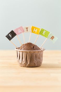 Chocolate muffins with small flag of a word father