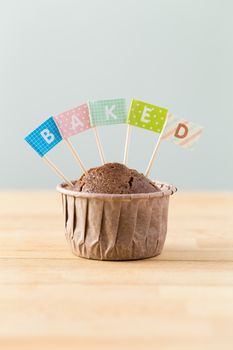 Chocolate muffins with small flag of a word baked