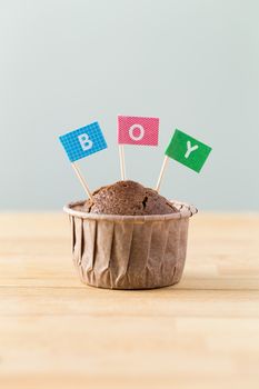 Chocolate muffins with small flag of a word boy