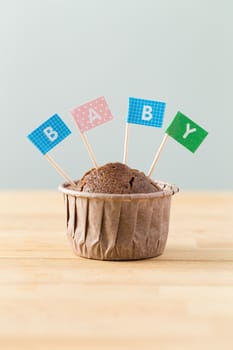 Chocolate muffins with small flag of a word baby