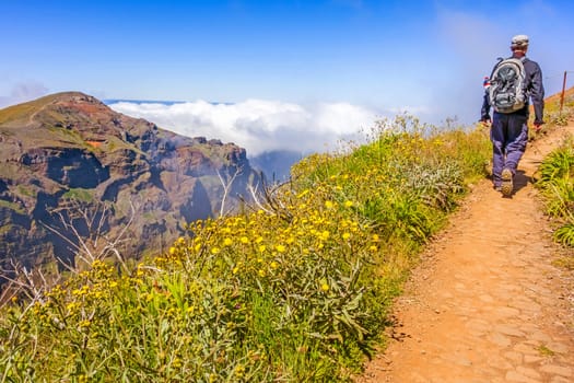 Hiker on a walk - mountain range on the Island of Madeira - mountainous nature landscape