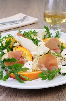 Light salad of pear, peach and ham, feta, arugula