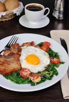 Scrambled eggs with bacon and spinach, cheese and cherry tomatoes