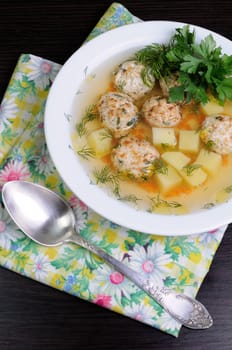 chicken broth of potatoes, carrots and meatballs sprinkled with dill