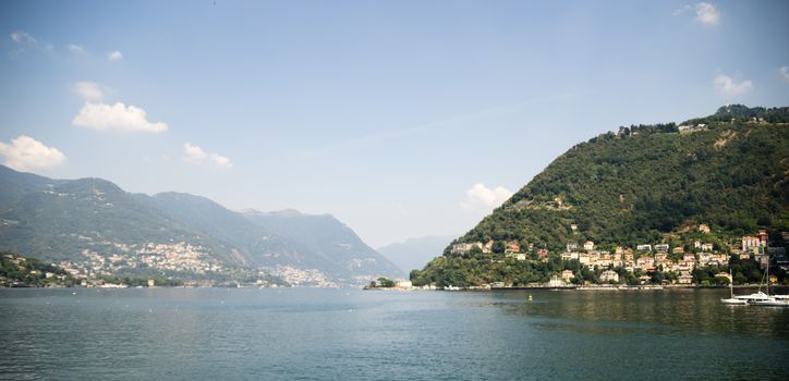 Como lake landscape with boats and water in summer travel