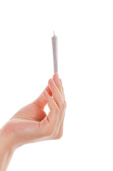 Female hand holding cannabis joint isolated on white background. Medical marijuana.