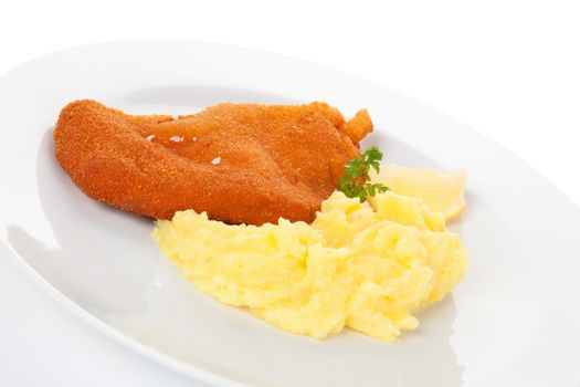 Delicious wiener schnitzel with mashed potatoes on plate on white background. Traditional european cuisine.