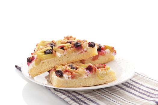 Traditional rhubarb cake on white plate isolated on white background. Culinary sweet dessert eating. 