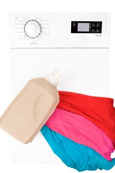 Laundry background. Top loading washing machine with natural organic detergent and colorful clothing isolated on white background, top view.