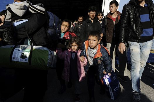 GREECE, Port of Piraeus: Refugees make their way through the Port of Piraeus near Athens, Greece on November 6, 2015, shortly after two ferries arrived from Mytilene and Chios carrying roughly 3,000 migrants. The latest influx has brought tens of thousands of people seeking new lives in Europe after fleeing from the instability in the Middle East and northern Africa.