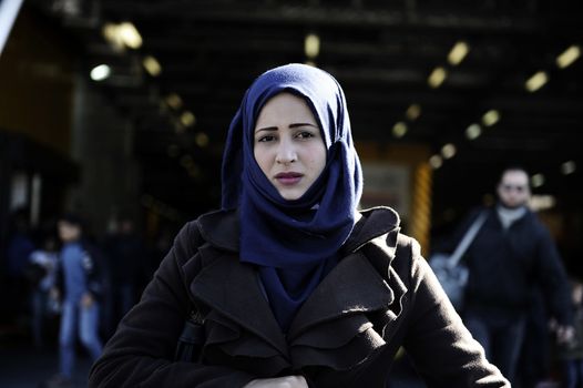 GREECE, Port of Piraeus: A refugee makes her way through the Port of Piraeus near Athens, Greece on November 6, 2015, shortly after two ferries arrived from Mytilene and Chios carrying roughly 3,000 migrants. The latest influx has brought tens of thousands of people seeking new lives in Europe after fleeing from the instability in the Middle East and northern Africa.