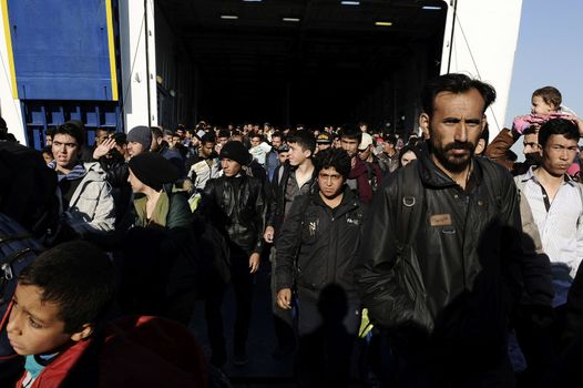 GREECE, Port of Piraeus: Refugees make their way through the Port of Piraeus near Athens, Greece on November 6, 2015, shortly after two ferries arrived from Mytilene and Chios carrying roughly 3,000 migrants. The latest influx has brought tens of thousands of people seeking new lives in Europe after fleeing from the instability in the Middle East and northern Africa.