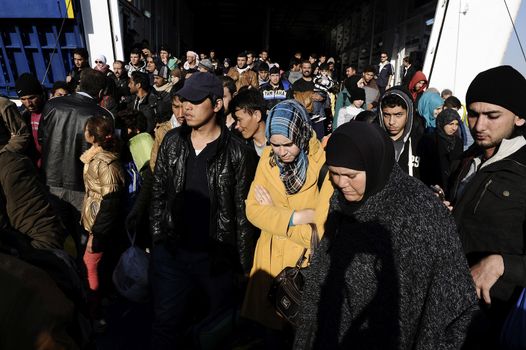GREECE, Port of Piraeus: Refugees make their way through the Port of Piraeus near Athens, Greece on November 6, 2015, shortly after two ferries arrived from Mytilene and Chios carrying roughly 3,000 migrants. The latest influx has brought tens of thousands of people seeking new lives in Europe after fleeing from the instability in the Middle East and northern Africa.