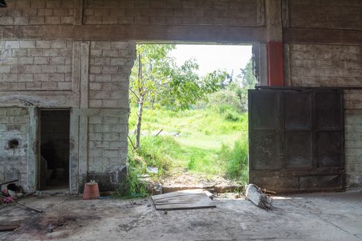 Interior of an abandoned cellar with details of wear and tear by time. You can see flashes of sunlight that enter through gaps and windows.